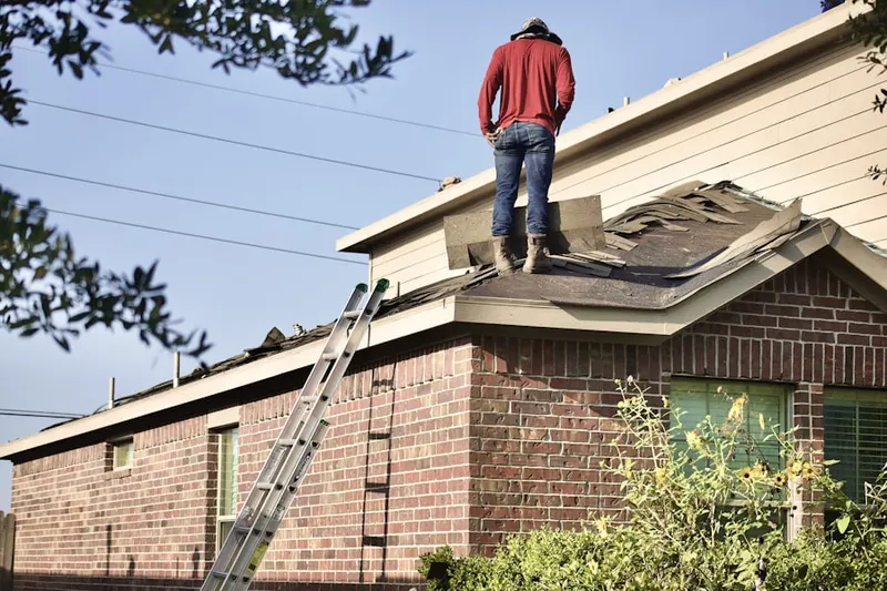 Professional roofer working on a residential roof in Franklin Town